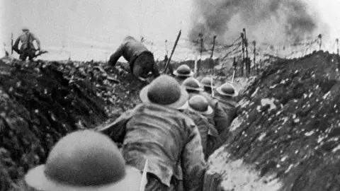 Soldiers of the English infantry in France, running out of their trenches at the signal to assault during World War One.