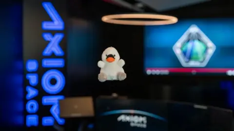 The image of Joy,  a small, white toy swan that would be the "the fifth crew member" on Axiom 4