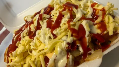 Caoimhinn Campbell A large chicken box in a plastic container with a number of sauces