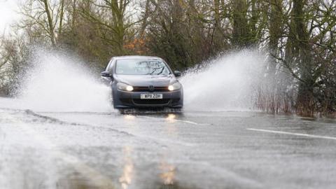 Generic image of a car driving through water