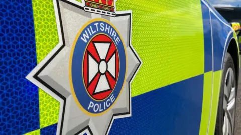A close-up image of the side of a Wiltshire Police car. 
