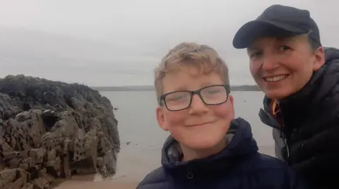 Nichola Rutherford Nichola and son on beach