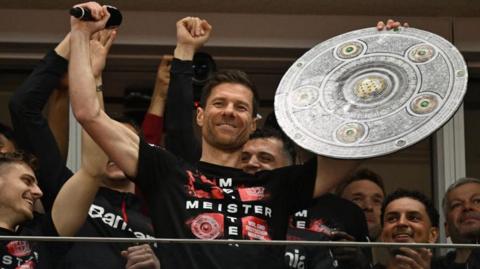 Xabi Alonso celebrates winning the Bundesliga with his players