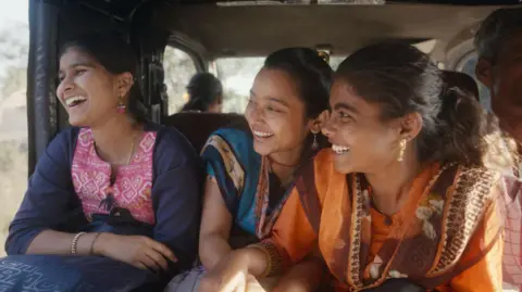 Courtesy: Sthal A still from the Marathi film Sthal: A Match shows three laughing young women.  The lead character played by Nandini Chikte is on the right