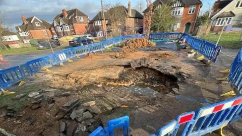 Burst water pipe on Kidmore Road, Caversham Heights, Berkshire