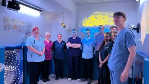 Derby and Burton Hospitals Charity The opening with staff and dignitaries posing for a photo in the room