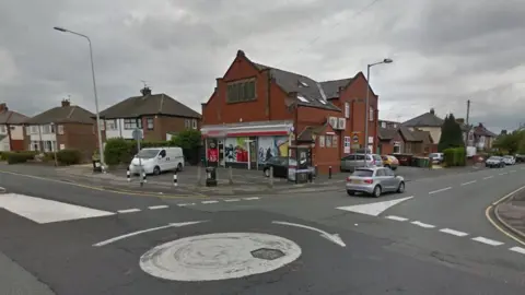 Google streetview of Spar store with bollards at a roundabout junction.