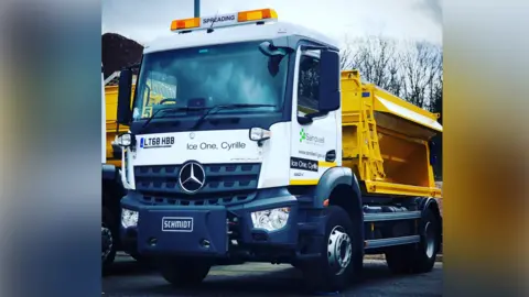 Sandwell Council A white and yellow gritting truck parked outside on a road