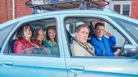 BBC/Toffee International Ltd/Tom Jackson Ruth Jones, Joanna Page, Melanie Walters, Rob Brydon, and Mathew Horne pictured on set in Trinity Street, Barry.