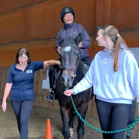 Kiwi House Staff at Wenlo helping an 82-year-old woman ride a horse