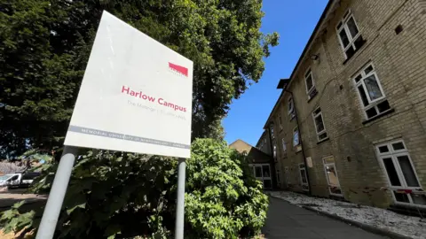 Stuart Woodward/BBC A large white sign that reads Harlow Campus and a building behind.
