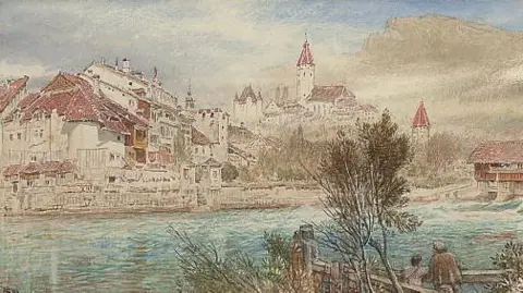 Maidstone Museum A watercolour of Thun in Switzerland, painted in 1898 by Albert Goodwin, shows two figures leaning on a bridge next to a tree in the foreground, with a river in the middle of the picture andthe town of Thun on a hill in the background. The roofs have red tiles.