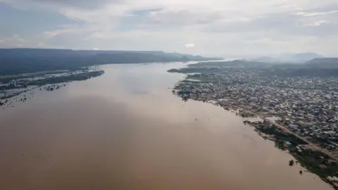 AFP An aerial view of a wide River Niger flowing past a city on the right bank.