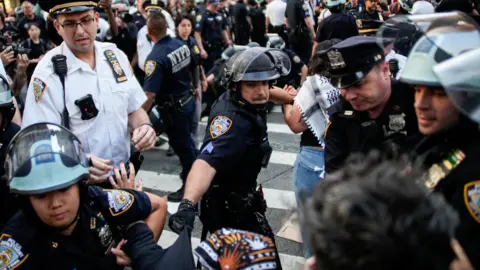 Reuters A police officer pushing protesters in New York