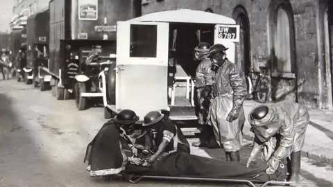 London Ambulance Service Women completing casualty training in gas masks during World War II