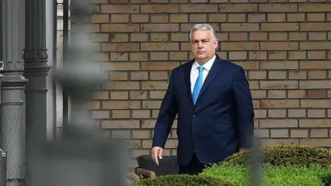 Ferenc Isza/AFP via Getty Images Outgoing Hungarian Prime Minister Viktor Orban, wearing a blue suit and light-blue tie, arrives at the presidential Sandor Palace in Budapest on April 15, 2026 to meet Hungary's president