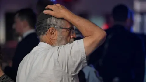 Getty A man in a kippah holds his hand to his head