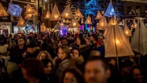 Geoff Russell-Hayward MBE at RHImageArt Crowds of people carrying lanterns in the street.