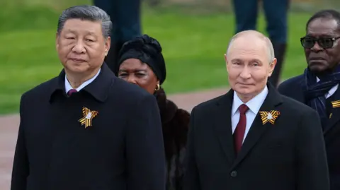 China's President Xi and Russia's President Putin stand side-by-side