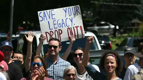 Getty Images A sign outside the rally venue calls for Biden to drop out