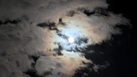 Kay Fautley/BBC Weather Watchers A bright Moon is shrouded in cloud 