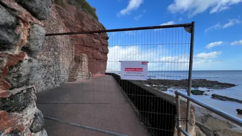 The Millenium Walkway with a fence in front of the entrance saying Footpath Closed