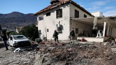 Israeli troops at damaged house in northern Israel after reports of projectiles coming from Lebanon