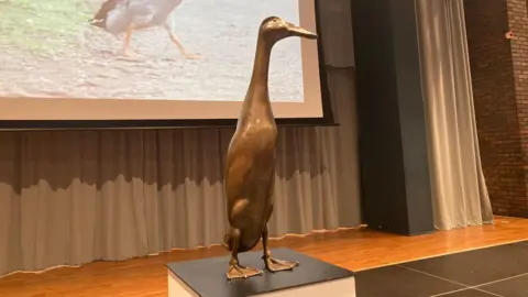 A statue of Long Boi, a 28in (70cm) cross between a mallard and an Indian runner