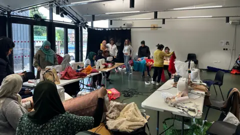 Alice Cunningham/BBC The sewing group in action one Friday in Ipswich