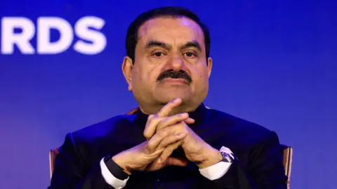  Indian billionaire Gautam Adani - wearing a black coat and a white shirt - attends the 51st Gems and Jewellery Awards in Jaipur, India, November 30, 2024. 
