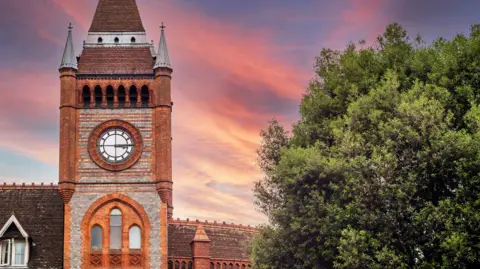 Getty Images A picture of the Town Hall's clock tower, with a tree to the right of the picture.