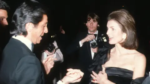 AFP via Getty Images Valentino and Jacqueline Kennedy Onassis attend the Metropolitan Museum of Art Costume Exhibit "Hapsburg Era Fashions" at the Metropolitan Museum of Art in New York City