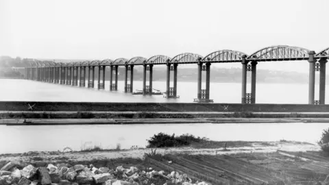 Getty Images A black and white photo of a railway bridge with 18 arches and spans