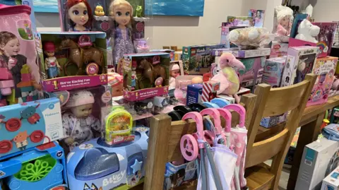 A collection of presents lined up in a room.