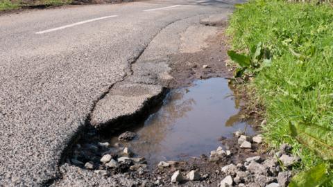 A pothole in a country road