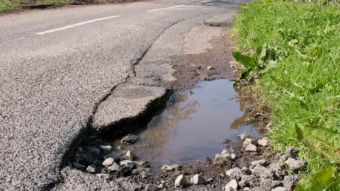 Getty Images A pothole in a country road