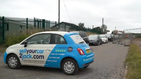 Access road blocked with cars and diggers