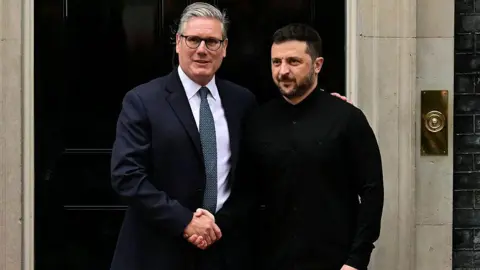 Getty Images Keir Starmer shakes his hands with Volodymyr Zelensky, and he is giving him in the steps of 10 Downing Street