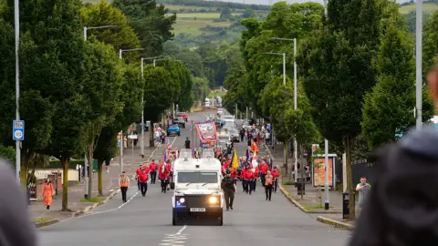 Pacemaker A band passes the Ardoyne shops 