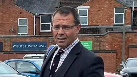 PA Media Callum Cowx with short brown hair in a car park
