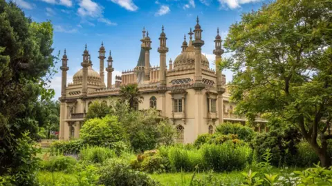 A brown building which minarets and crenallations