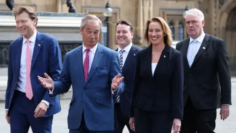 Reuters Five Reform MPs walking near Parliament. McMurdock is in the centre of the frame, at the rear.
