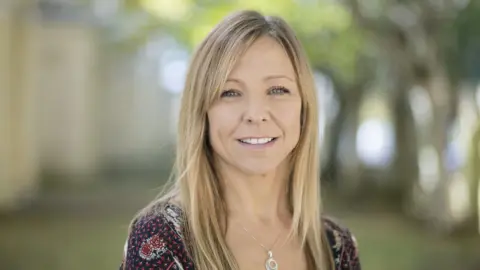 Close up of Claire Chick who is smiling at the camera.