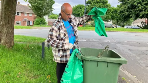 Andy Sherman picking up litter
