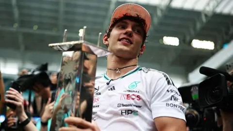 Kimi Antonelli holds his winner's trophy in Miami 