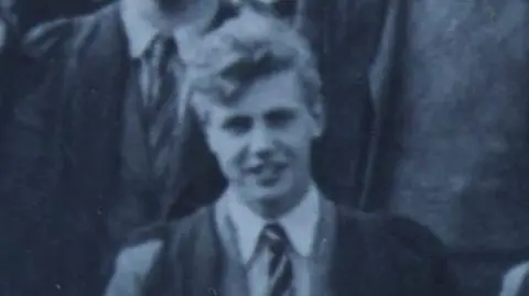 University of Leicester A black and white photo of a 19-year-old Sir David Attenborough, posing for an official University College, Leicester photograph. He is wearing a white shirt, tie and a jacket.
