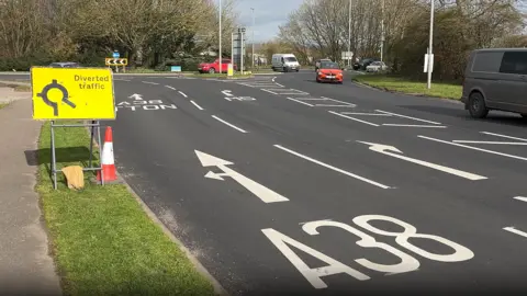 A view of the A38 heading towards Chelston Roundabout. There are fresh road markings on the tarmac.