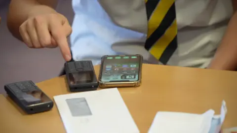 A Nokia phone next to a smartphone on a table