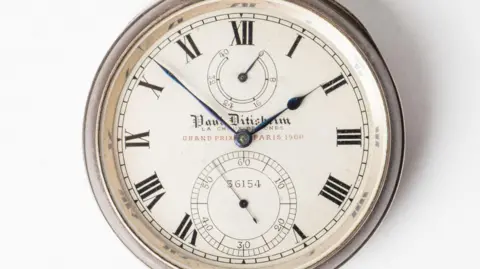 The Paul Ditisheim deck watch has a dial signed Paul Ditisheim, La Chaux-de-Fonds, Grand Prix Paris 1900, with Roman numeral times and blued steel hands.