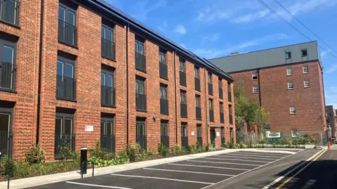 New three storey homes with car parking at the front.